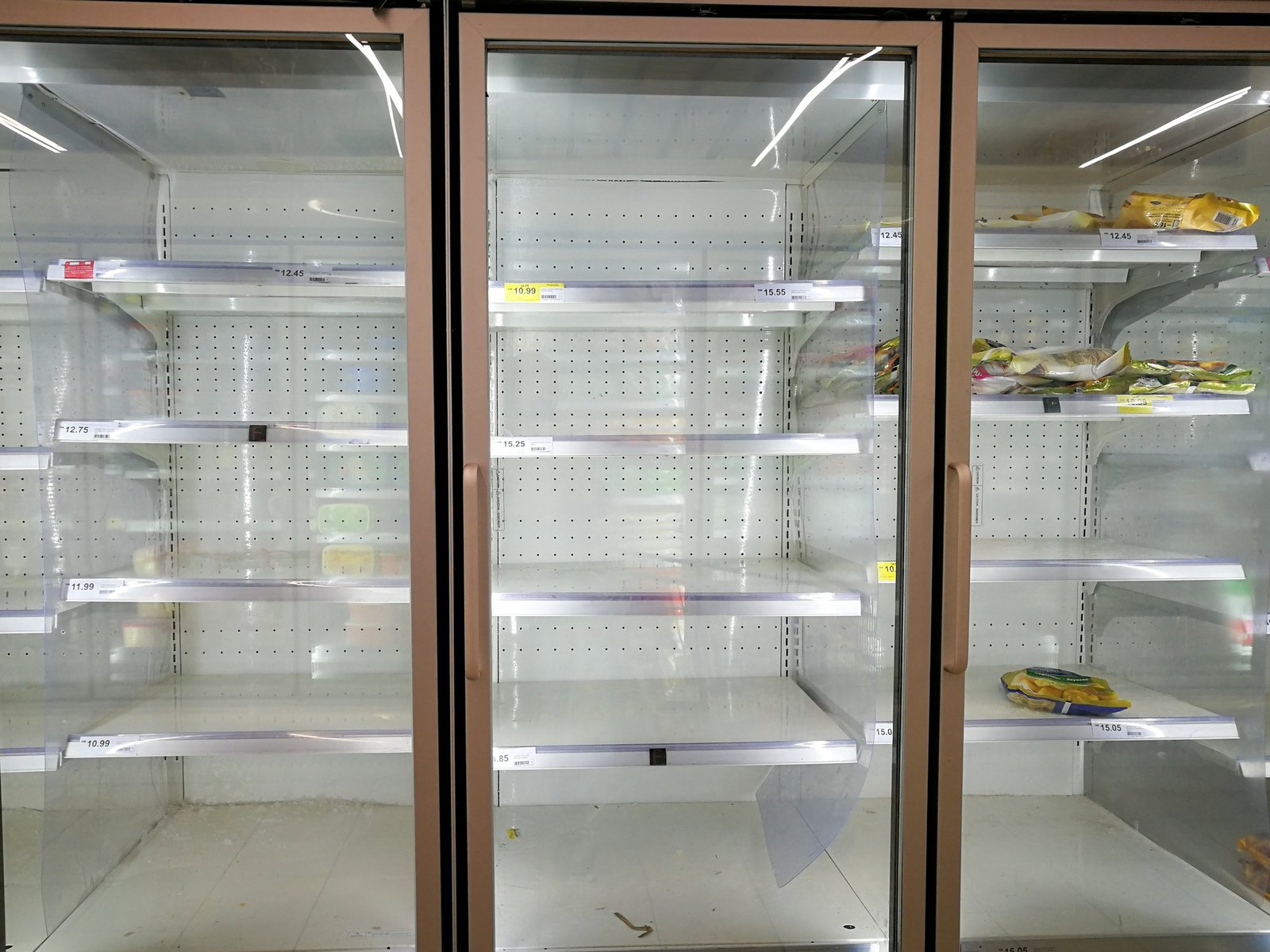 almost empty freezer at the supermarket during corona virus covid 19 lockdown